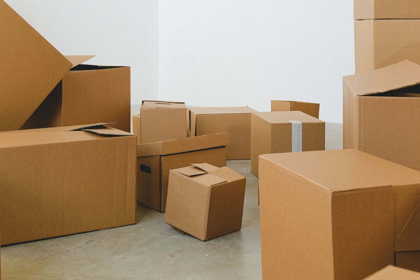 Moving boxes stacked on the floor of a new house