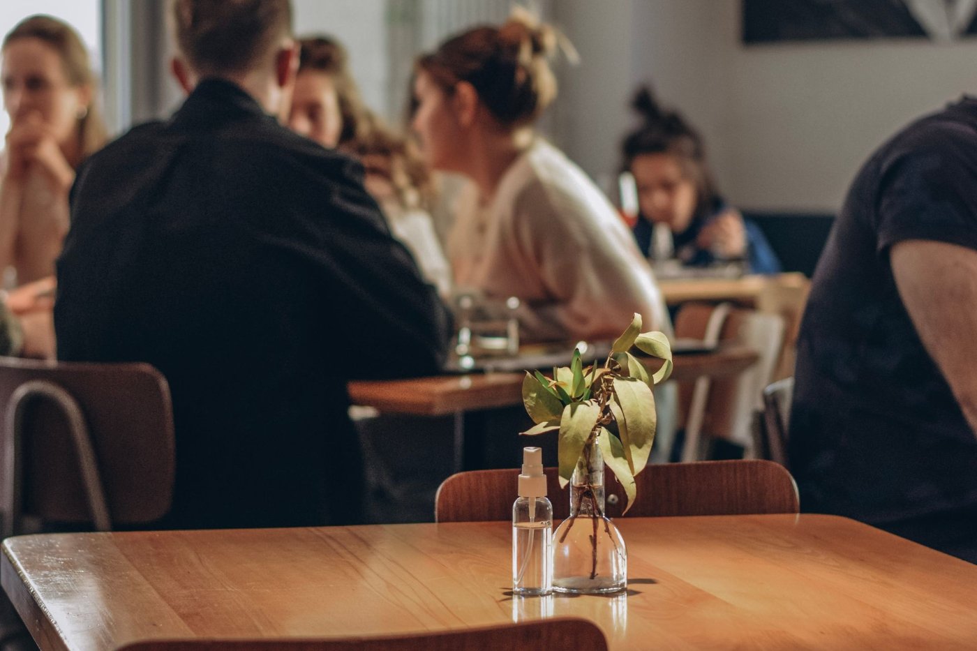 A casual restaurant dining scene with people seated at tables